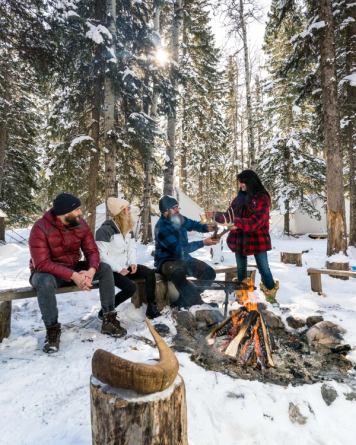 People sitting around fire at Painted Warriors