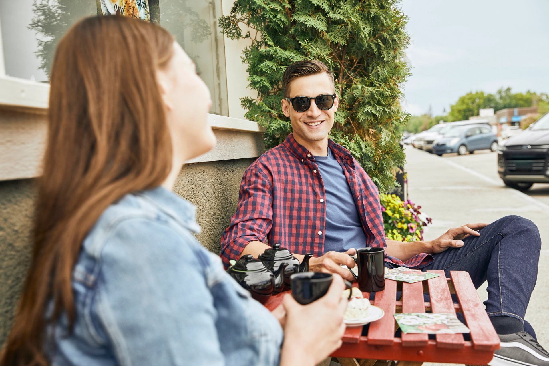 Couple drinking coffee outside on patio