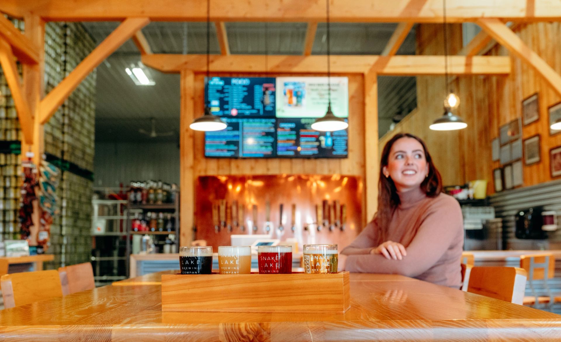 Interior of Snake Lake Brewing Company in Sylvan Lake Alberta with a flight of four beers