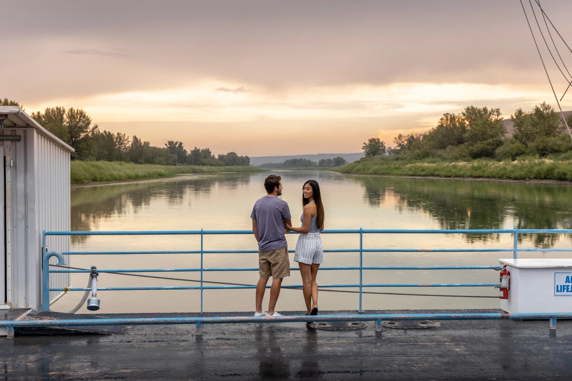 Couple standing on the Bleriot Ferry as it crosses the river