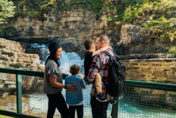 A family looking at a waterfall in Johnson Canyon near Banff