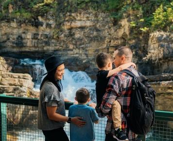 A family looking at a waterfall in Johnson Canyon near Banff