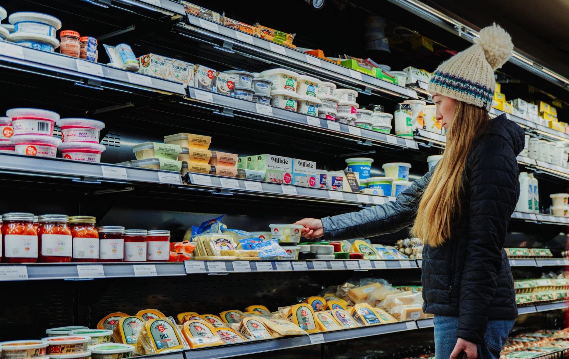A shopper browses a refrigerated section of local products in Canmore.
