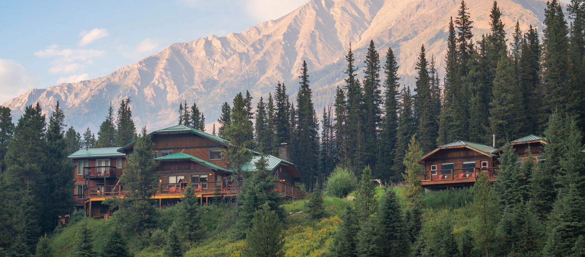 Cabins at Mount Engadine Lodge with Mountains in the background.