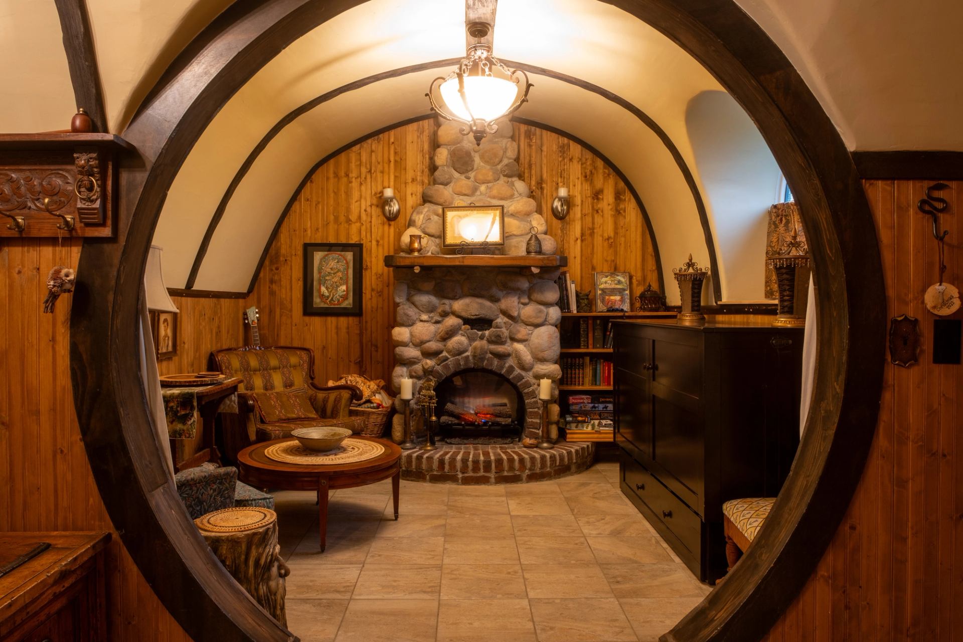 The circular doorways and warm wood interior of The Burrow at Good Knights Medieval Encampment.