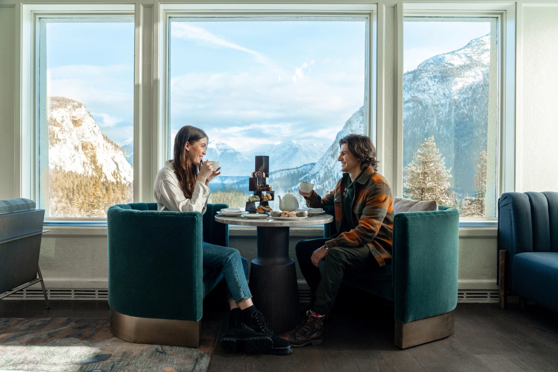 People enjoying drinks and the view from the Banff Springs hotel patio