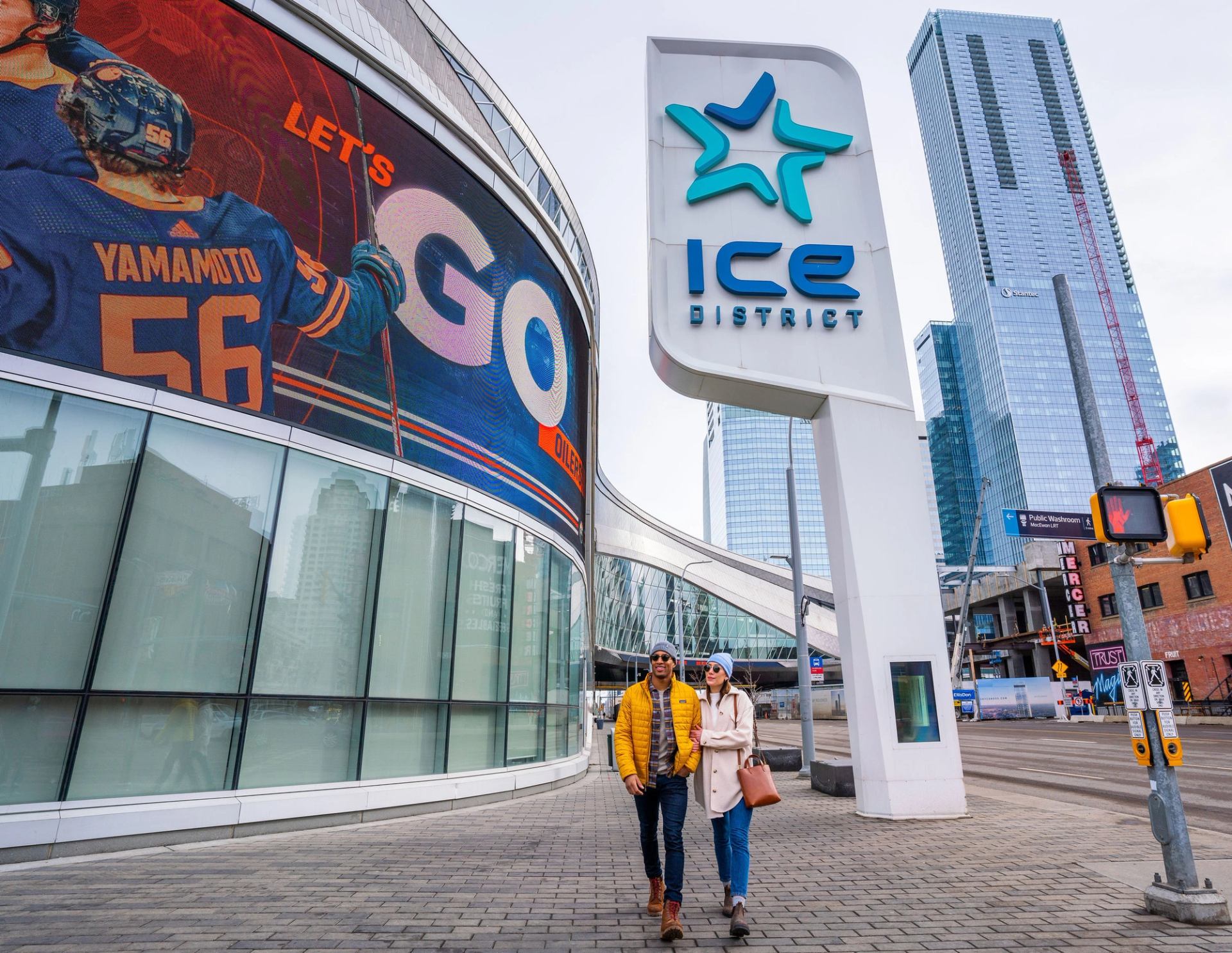 A couple walks down the sidewalk in Edmonton’s ICE District.