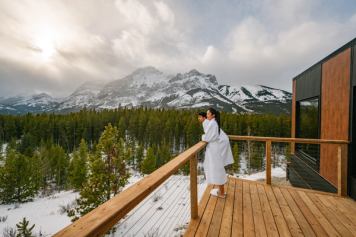 A couple look out from the deck at Skyridge Glamping in Kananaskis.