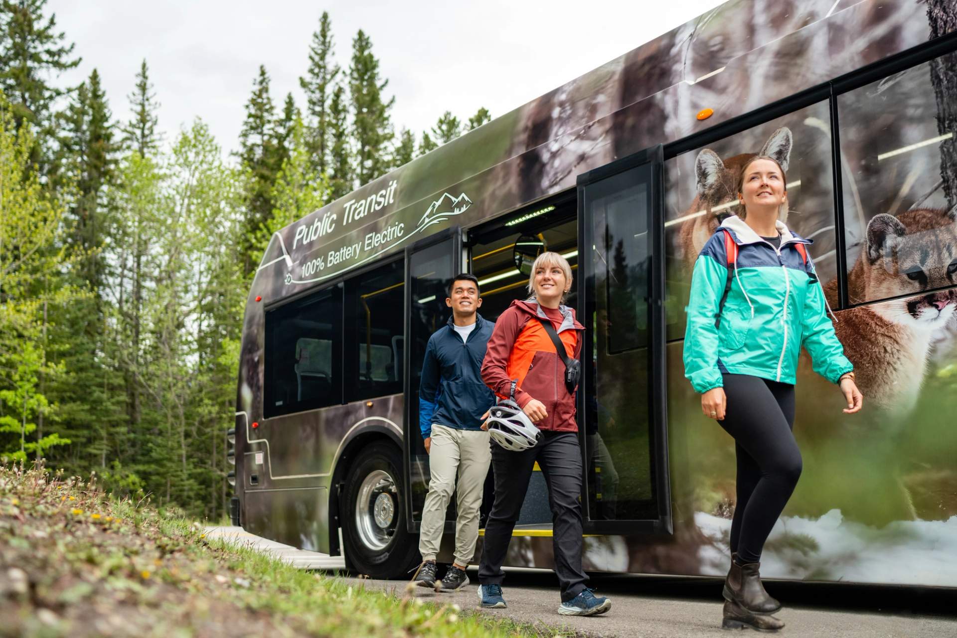 Tourists depart an electric shuttle bus.