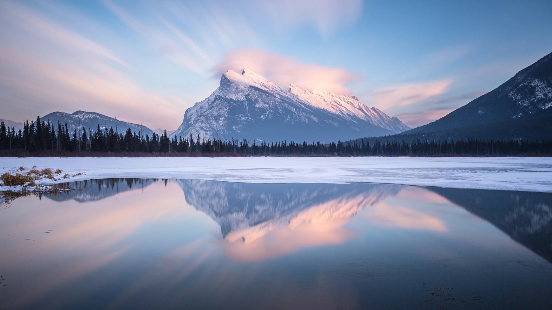 Mount Rundle reflected in the icy Vermilion Lakes in Banff National Park