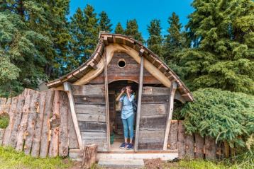 Women looking through binoculars standing in an old wooden home