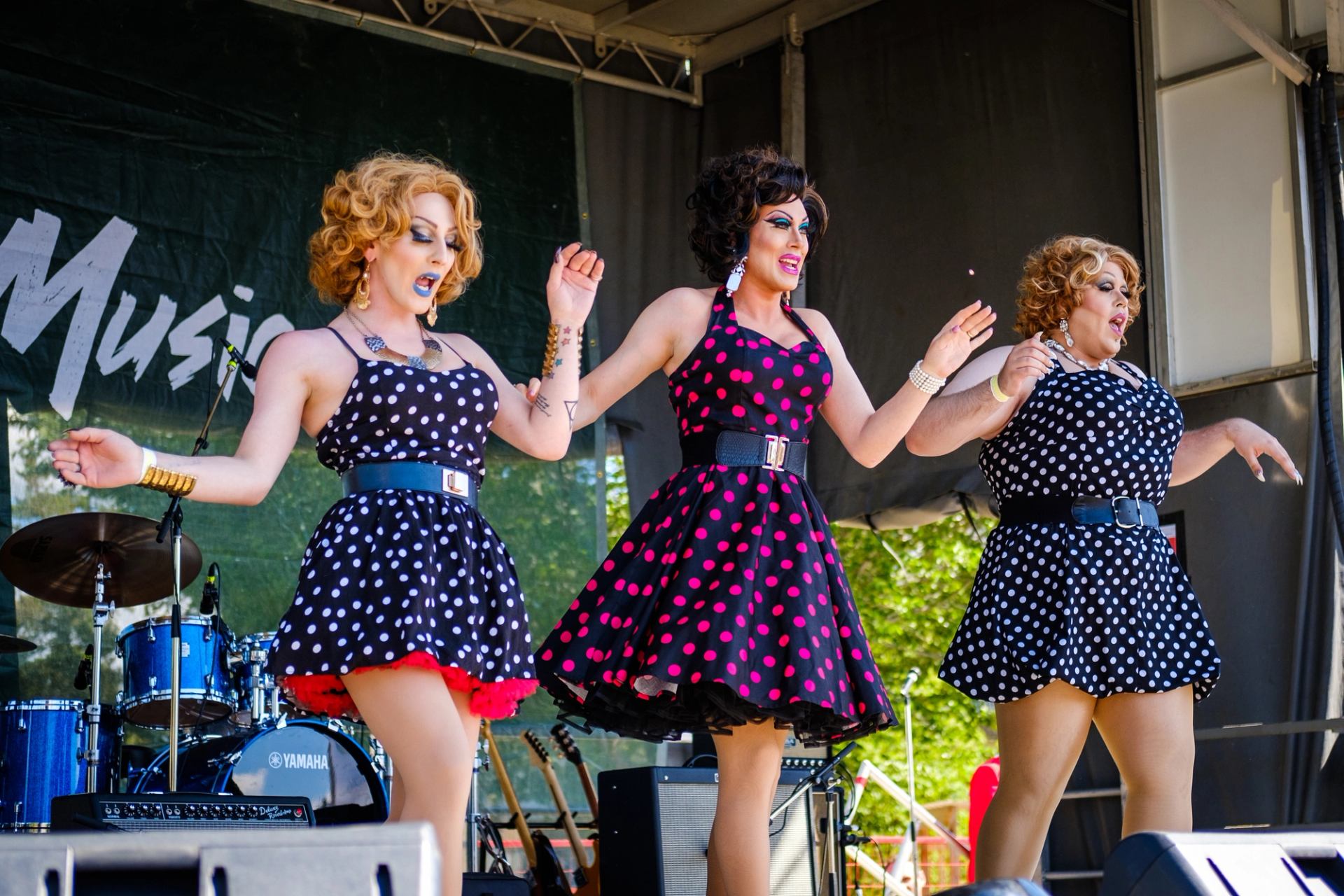 A group of performers dance on stage at the Edmonton Pride Festival.