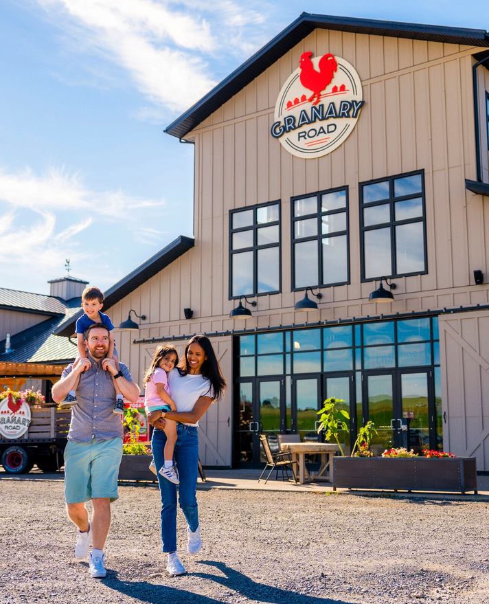Family walking away from the Granary Road Park, Farmyard & Farmer's Market.