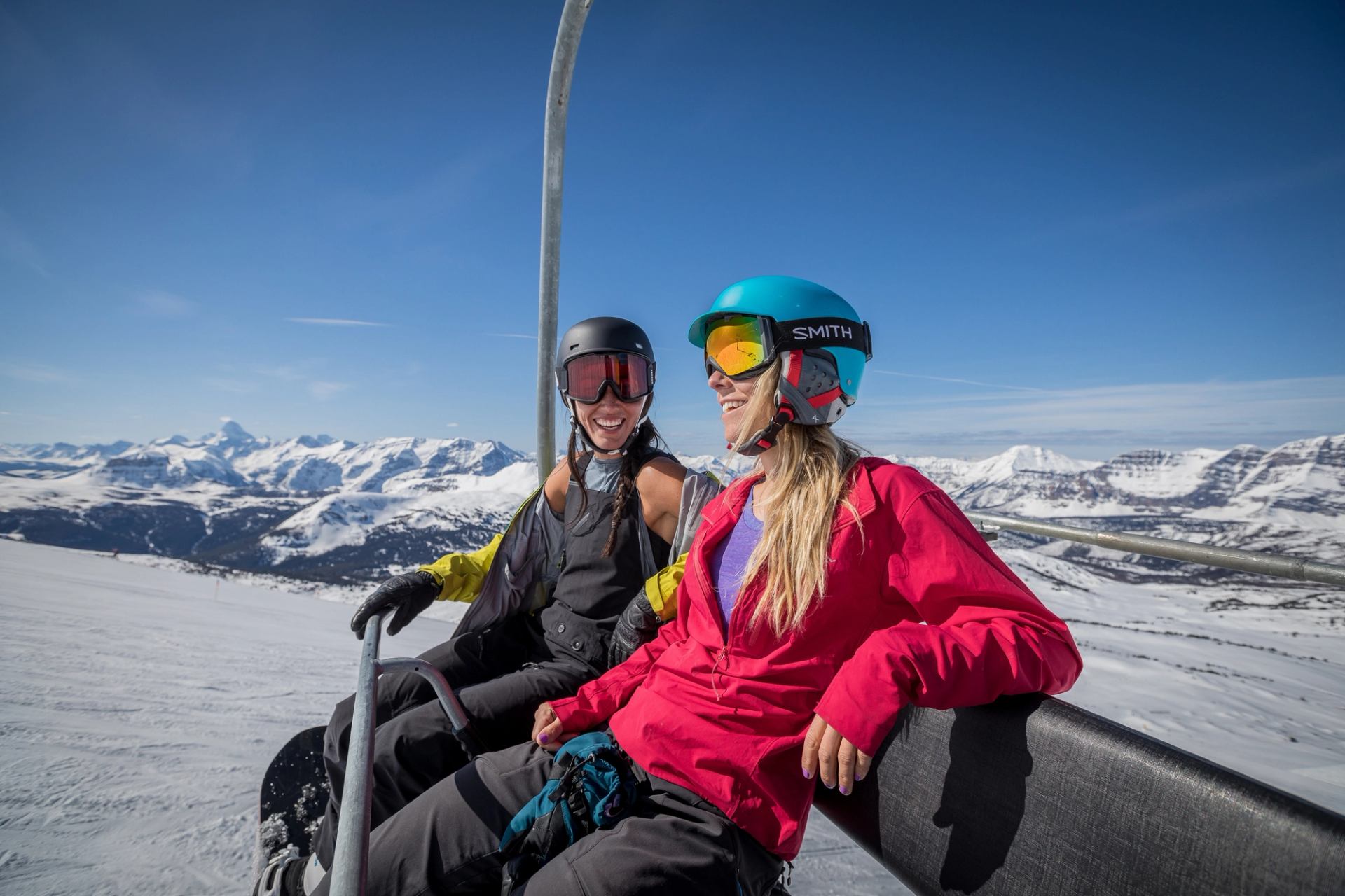 Skiers ride the chairlift at Sunshine Village on a warm spring day.