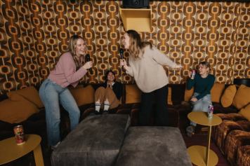 Friends singing karaoke at Moxy Hotel in Banff.