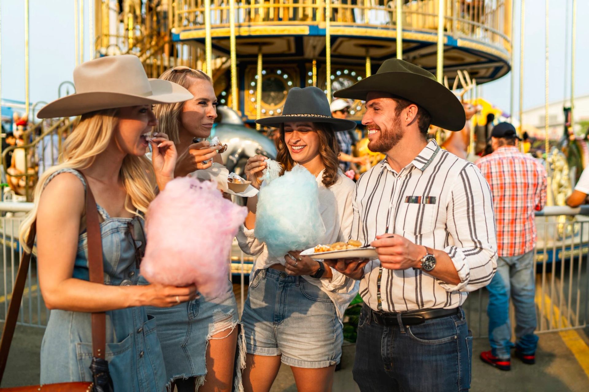 Friends eating cotton candy at the Calgary Stampede