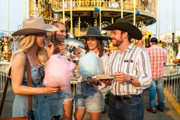 Friends eating cotton candy at the Calgary Stampede