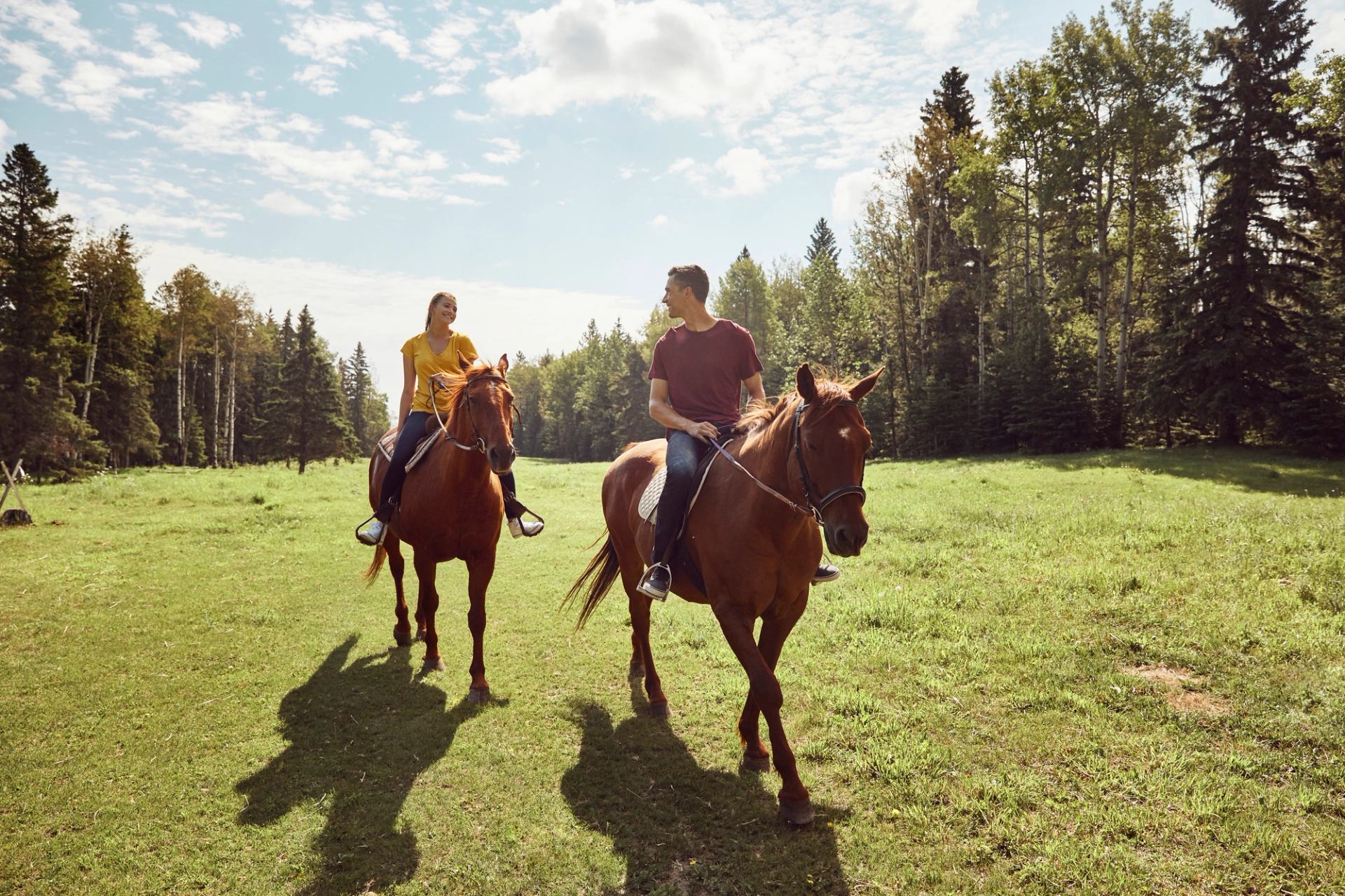 Couple horseback riding at Painted Warriors Ranch