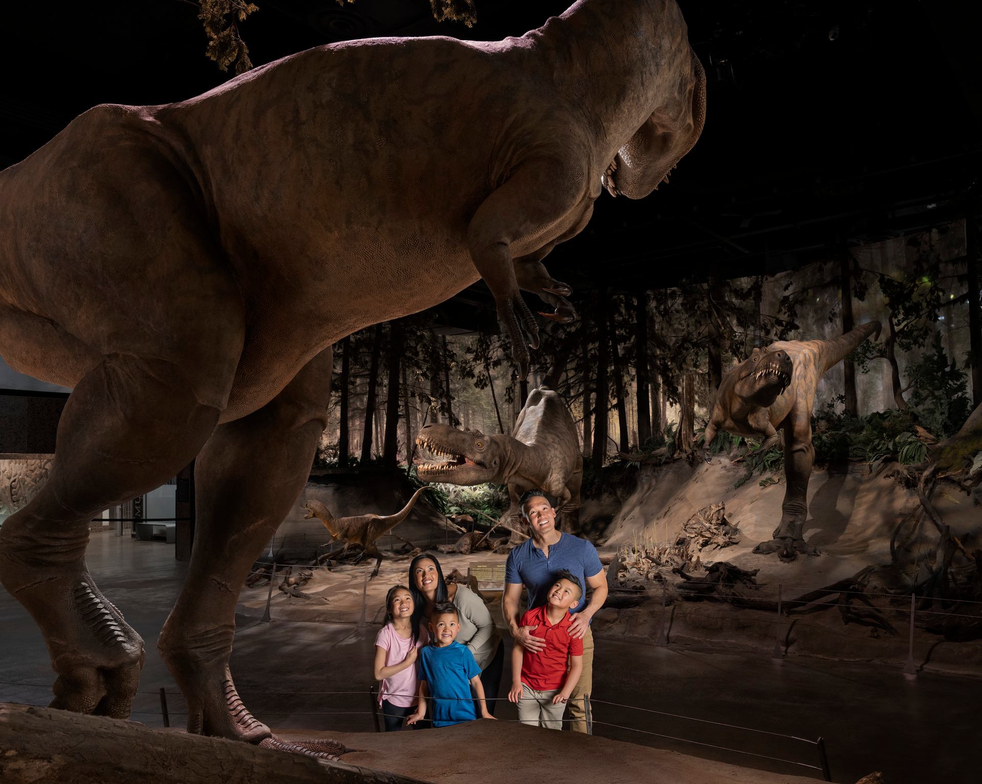 A family looking at a dinosaur display at the Royal Tyrrell Museum in Drumheller.