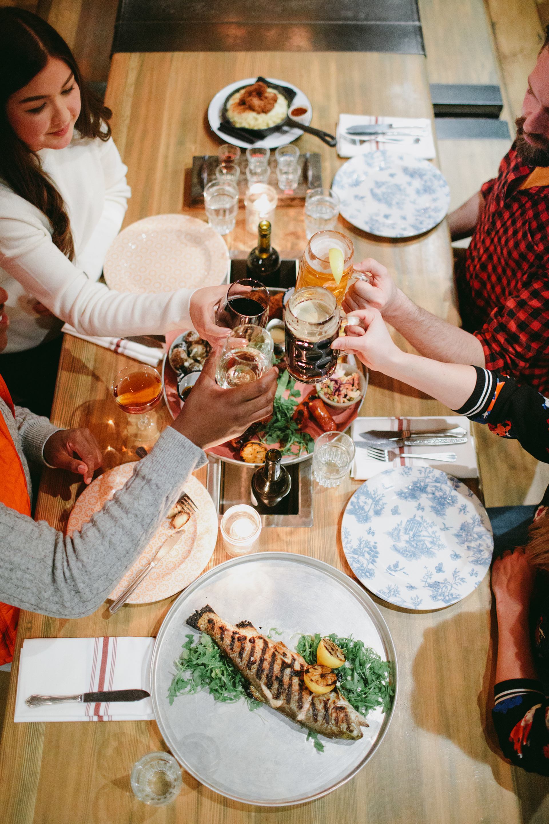 Friends cheers at Park Distillery Restaurant and Bar in Banff, Alberta