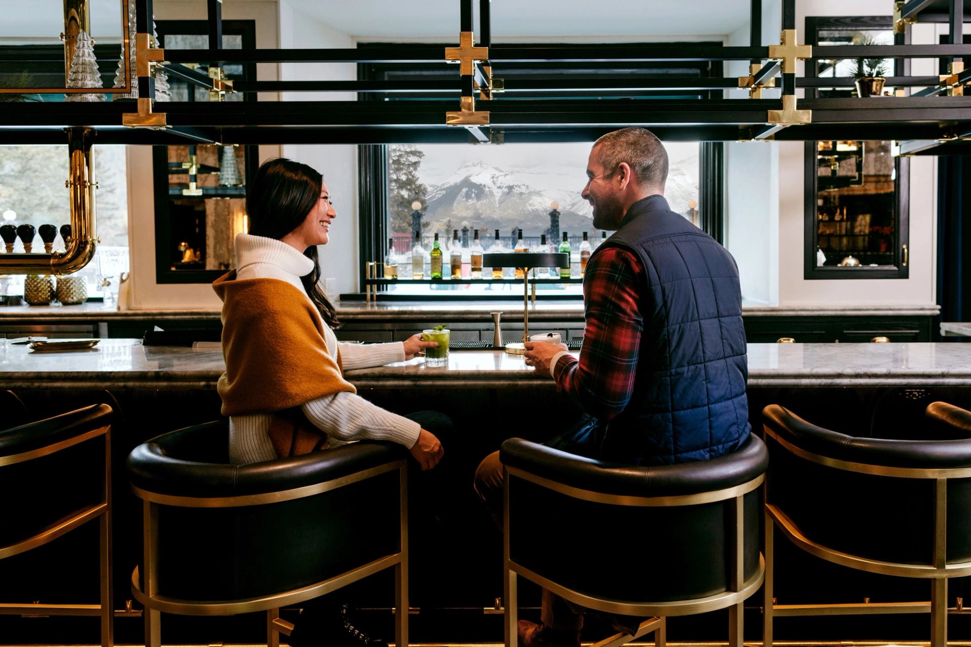 A couple enjoying cocktails in the Vermillion Room at the Banff Springs Hotel