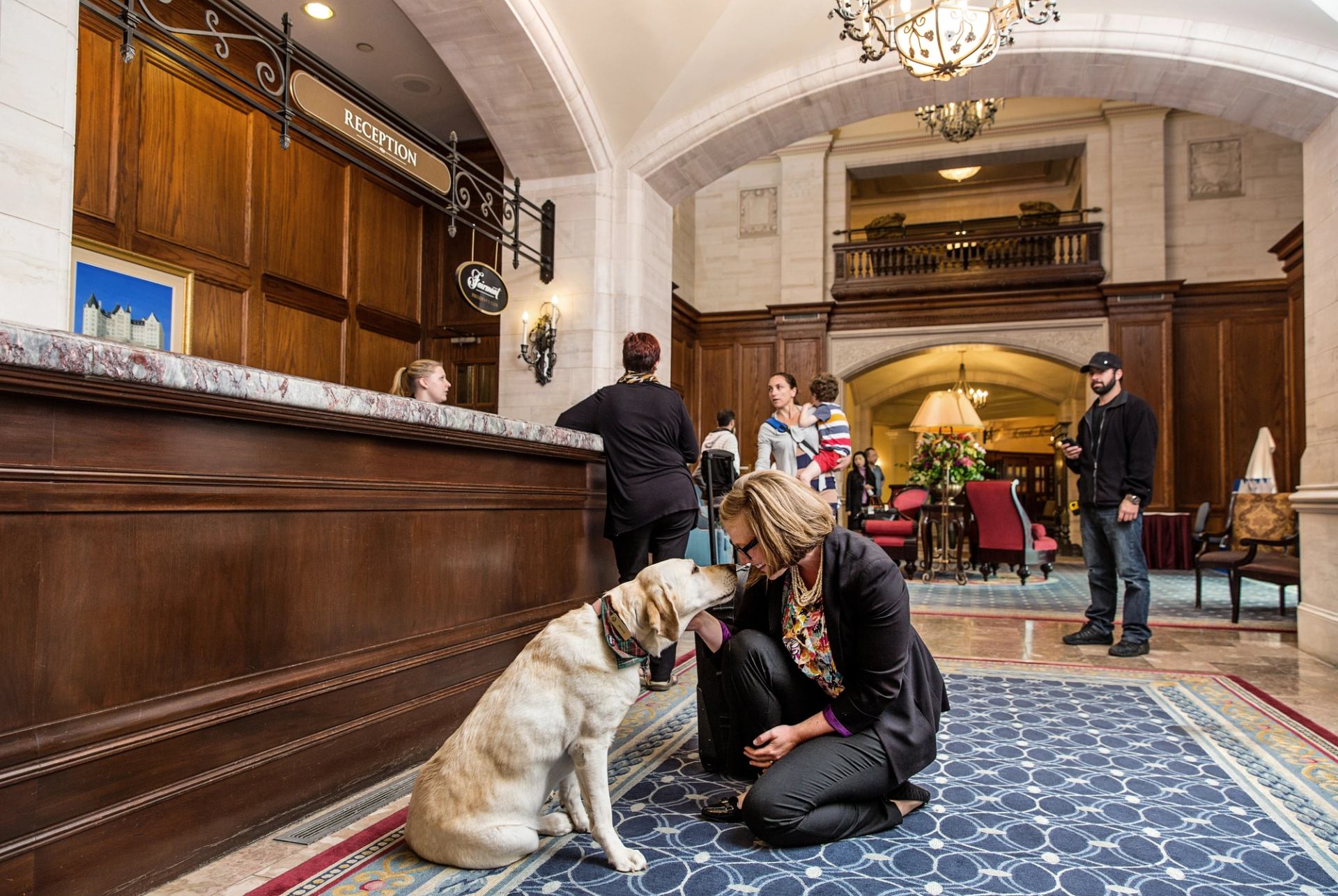 People inside the lobby of the dog-friendly Fairmont Hotel Macdonald in Edmonton