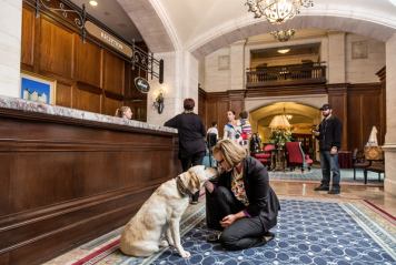 People inside the lobby of the dog-friendly Fairmont Hotel Macdonald in Edmonton