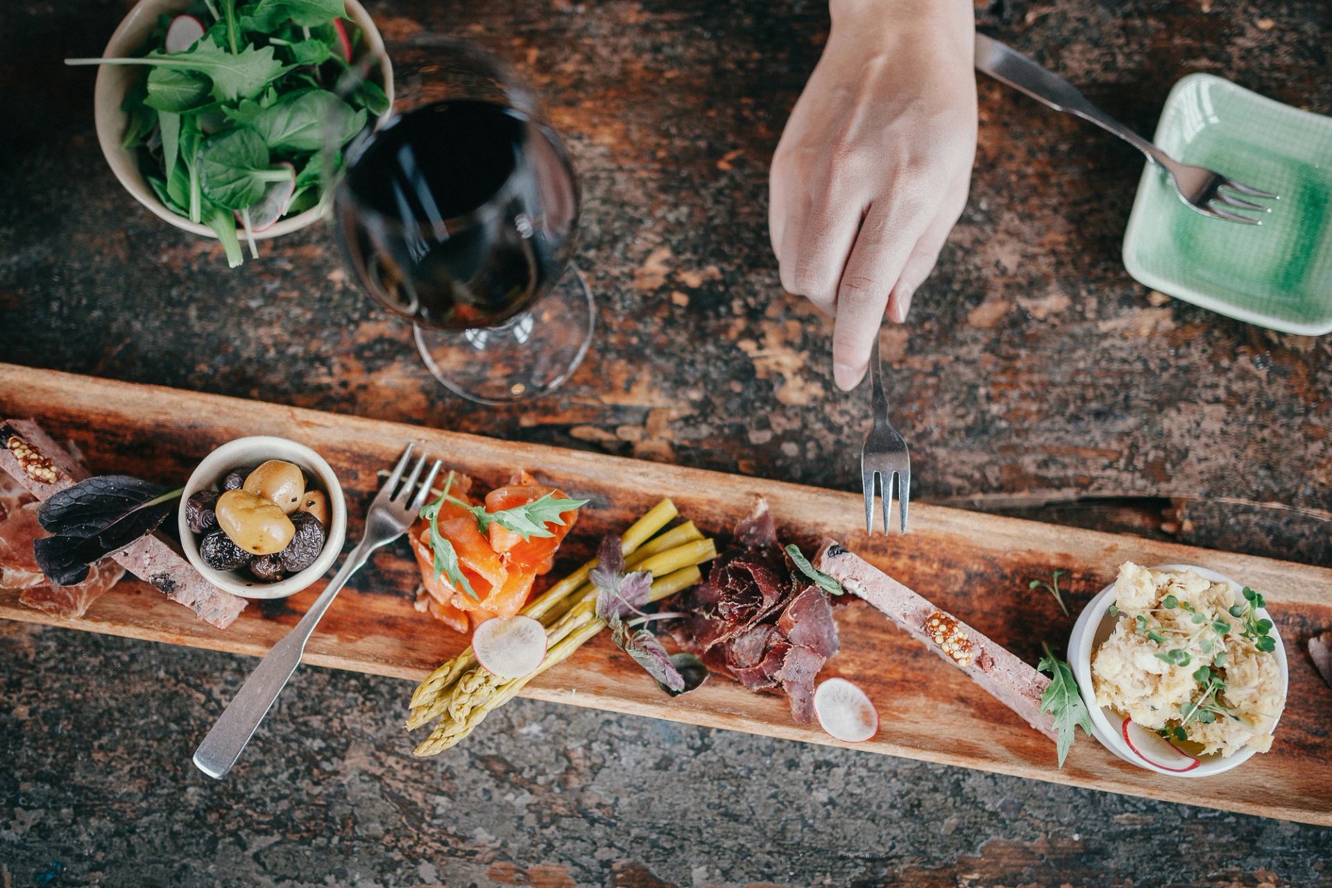 Closeup of food and wine on a wooden table.