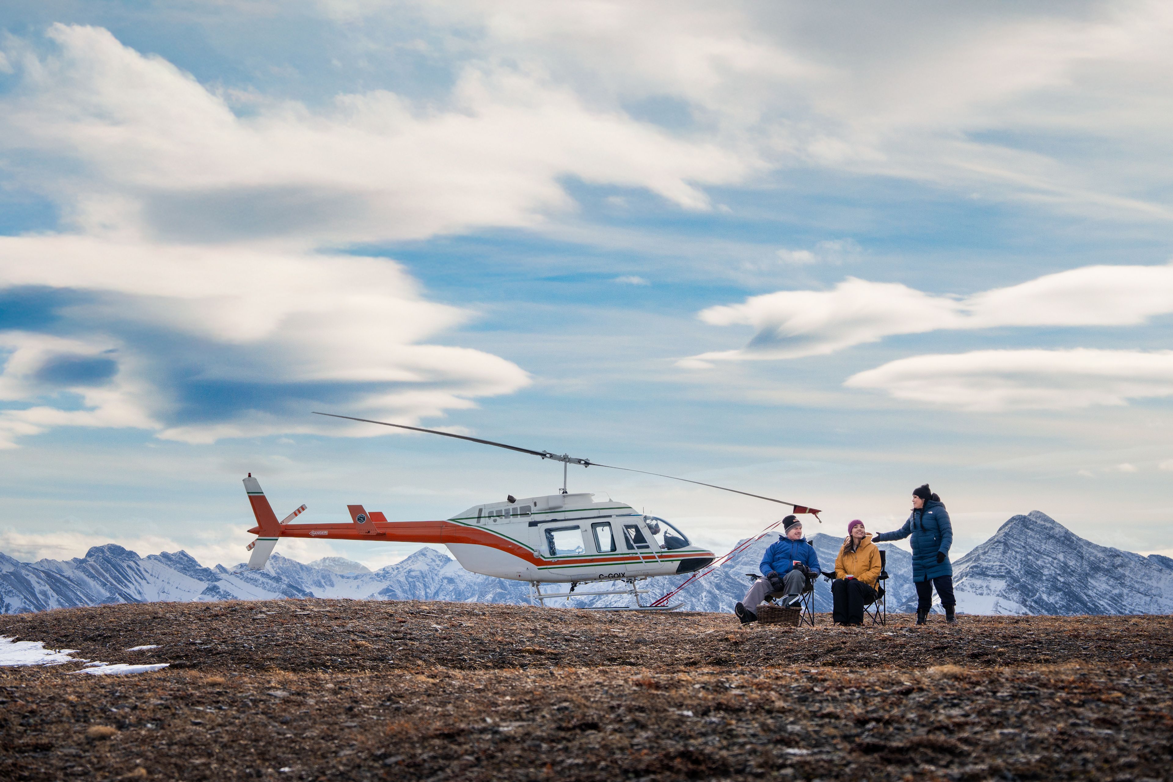 Helicopter on mountain top with guests