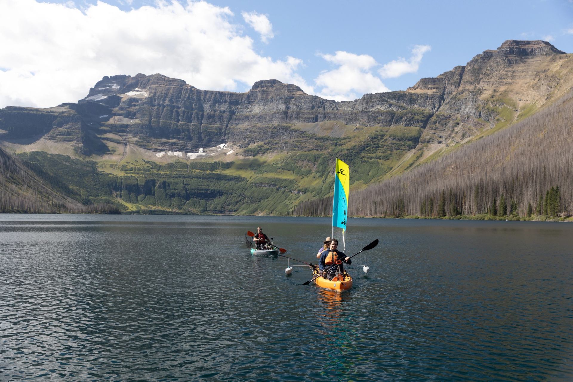 A group of people kayaking at Cameron Lake in Waterton Lakes National Park.