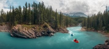 Two pack rafters on the beautiful turquoise Cline River.