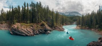 Two pack rafters on the beautiful turquoise Cline River.