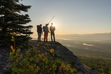 A group hike at sunrise on a climbing tour with Barry Blanchard and Yamnuska Mountain Adventures.