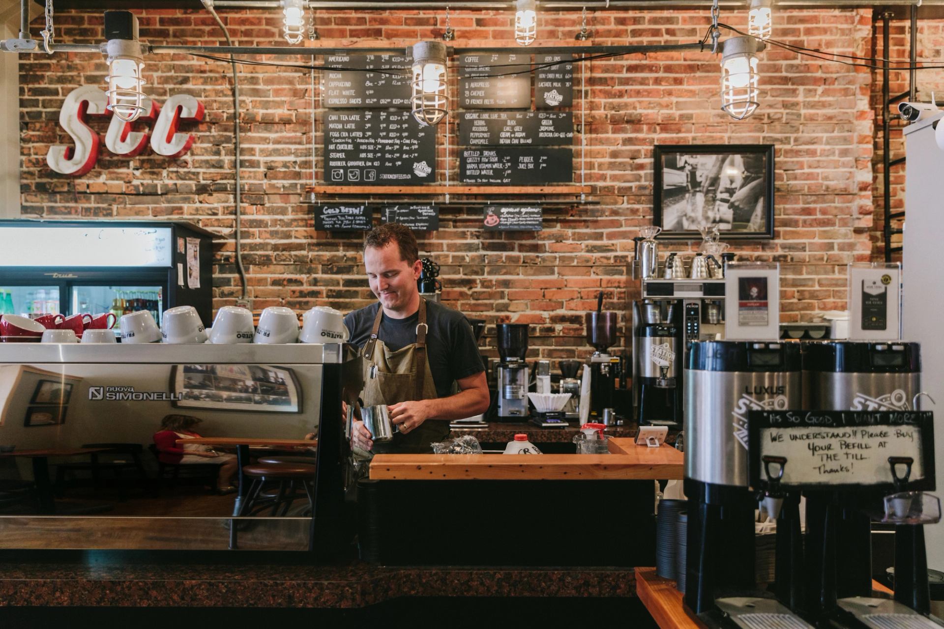 Barista behind counter at Medicine Hat coffee shop