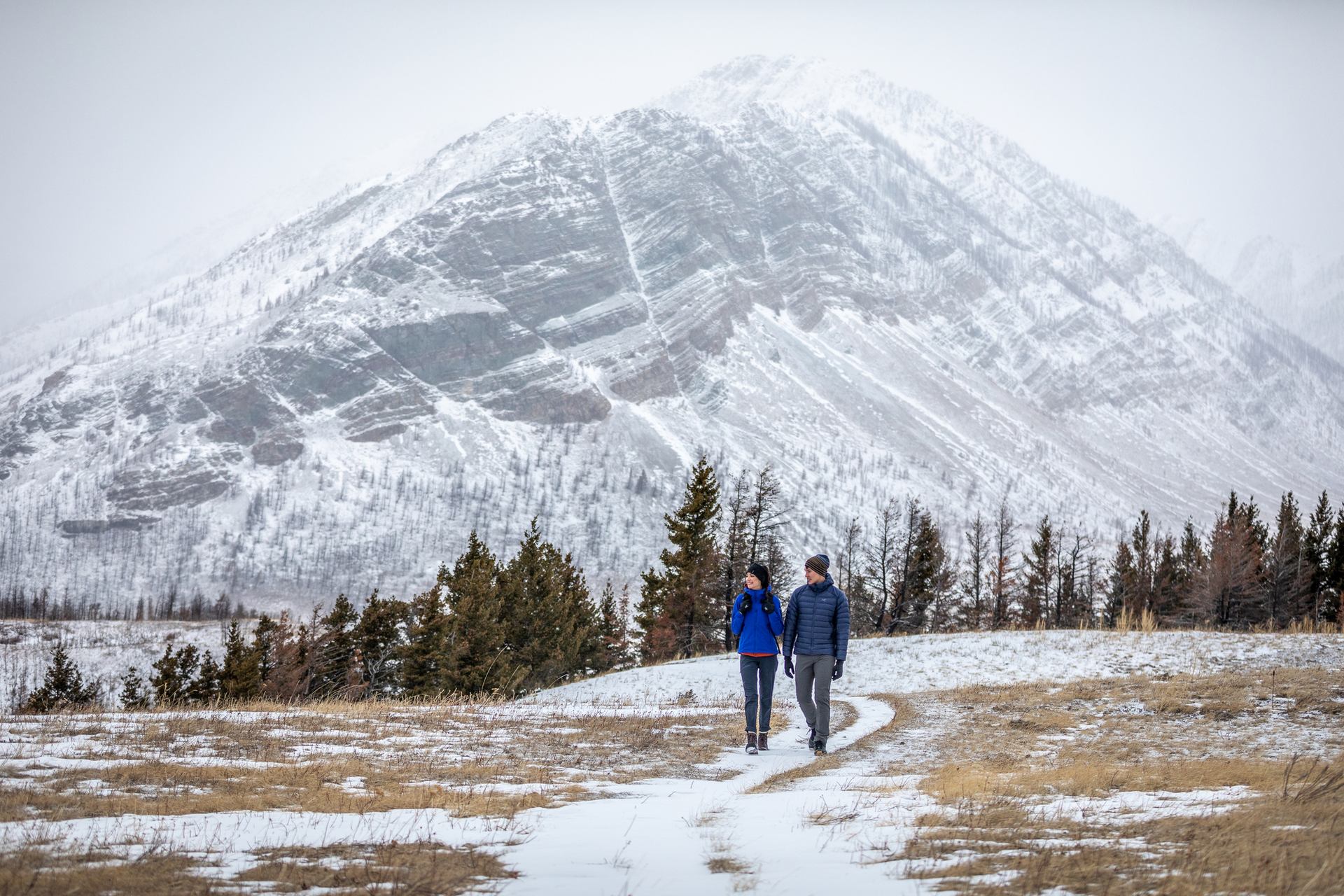 A couple winter hiking in Waterton Lakes National Park.