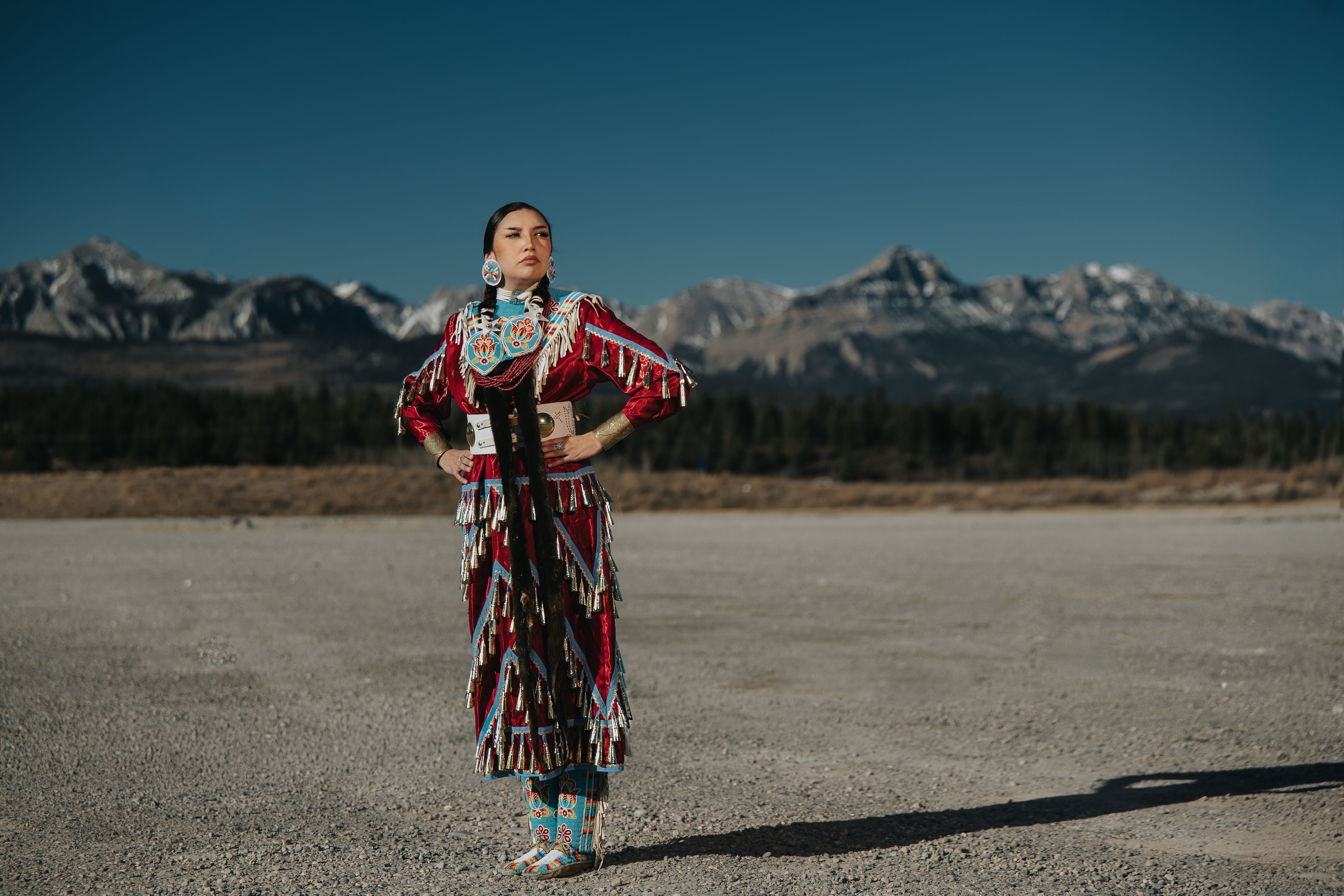 A solo Indigenous women in traditional dress at Stoney Nakoda Resort.