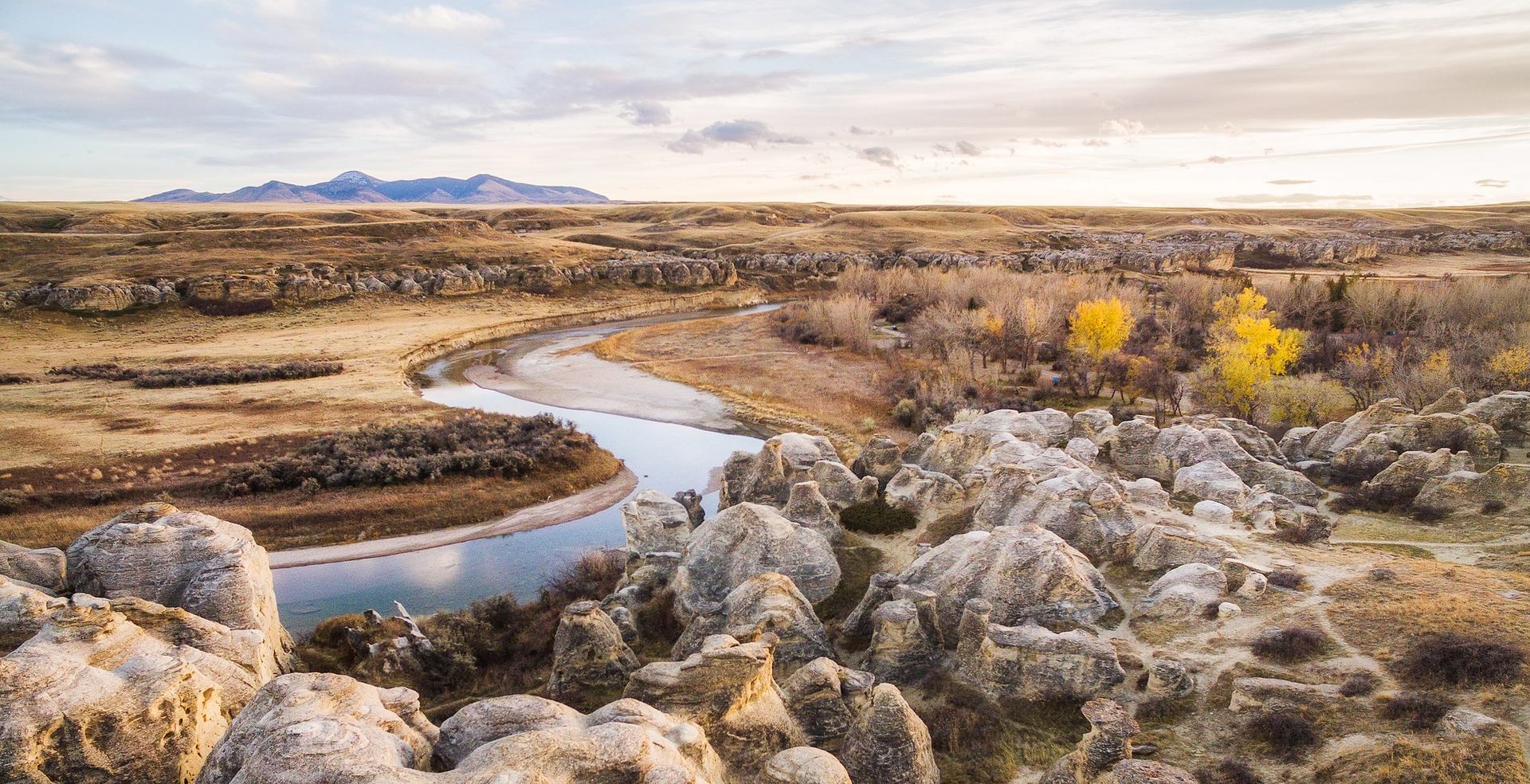 Wide shot of hiker walking through hoodoos