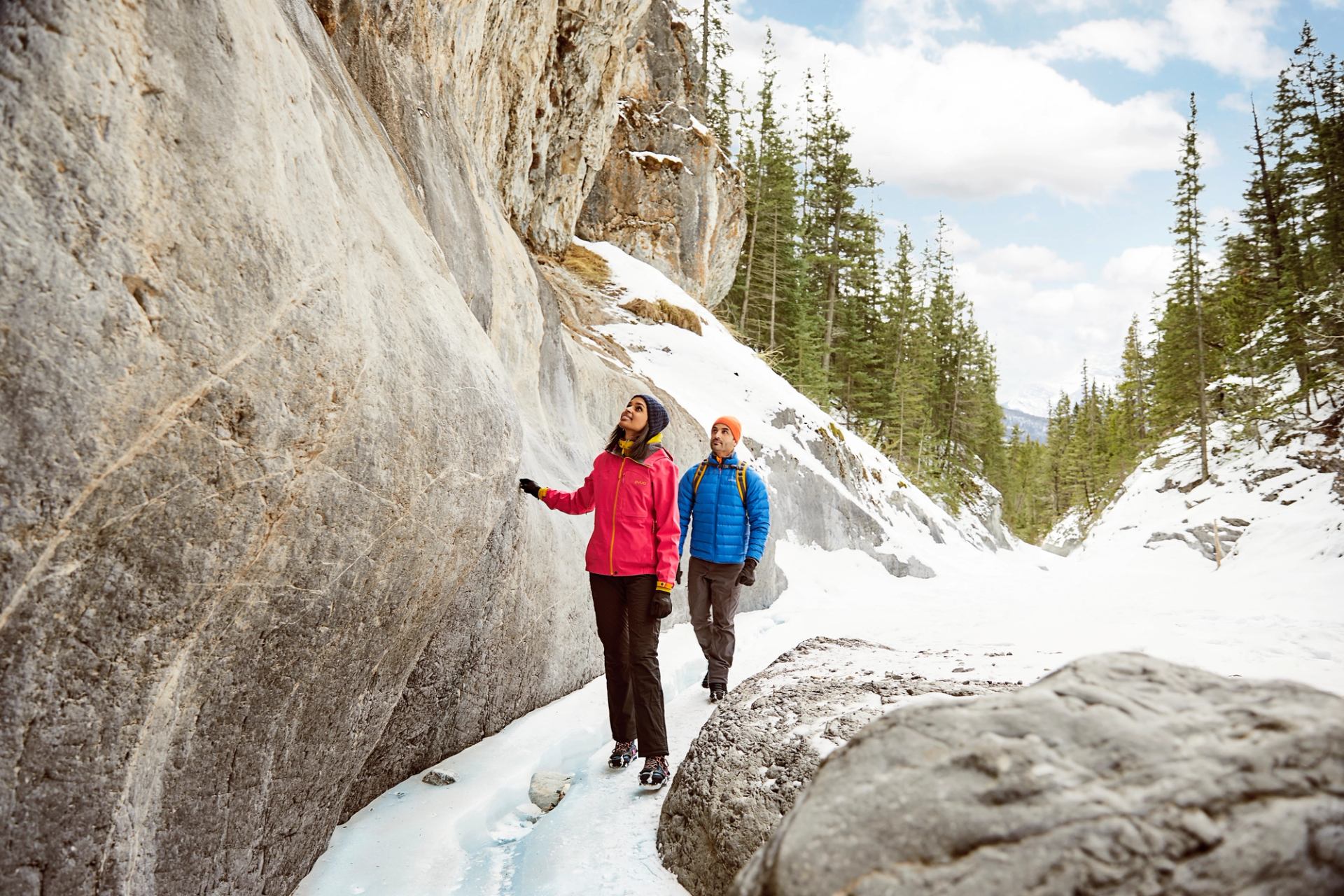 A couple ice walking and hiking through Grotto Canyon near Canmore in Kananaskis Country.