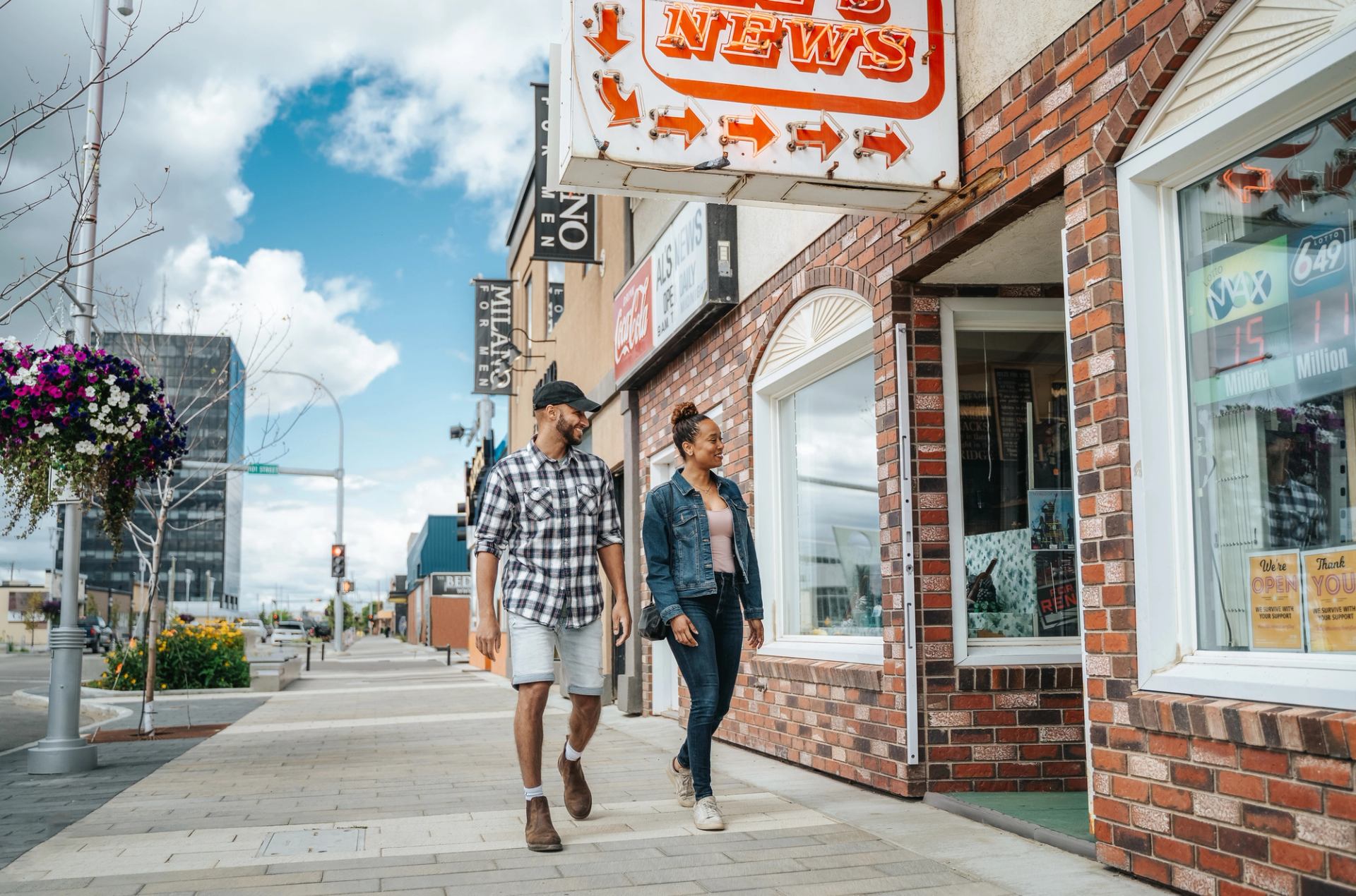 Couple walking through downtown Grande Prairie.