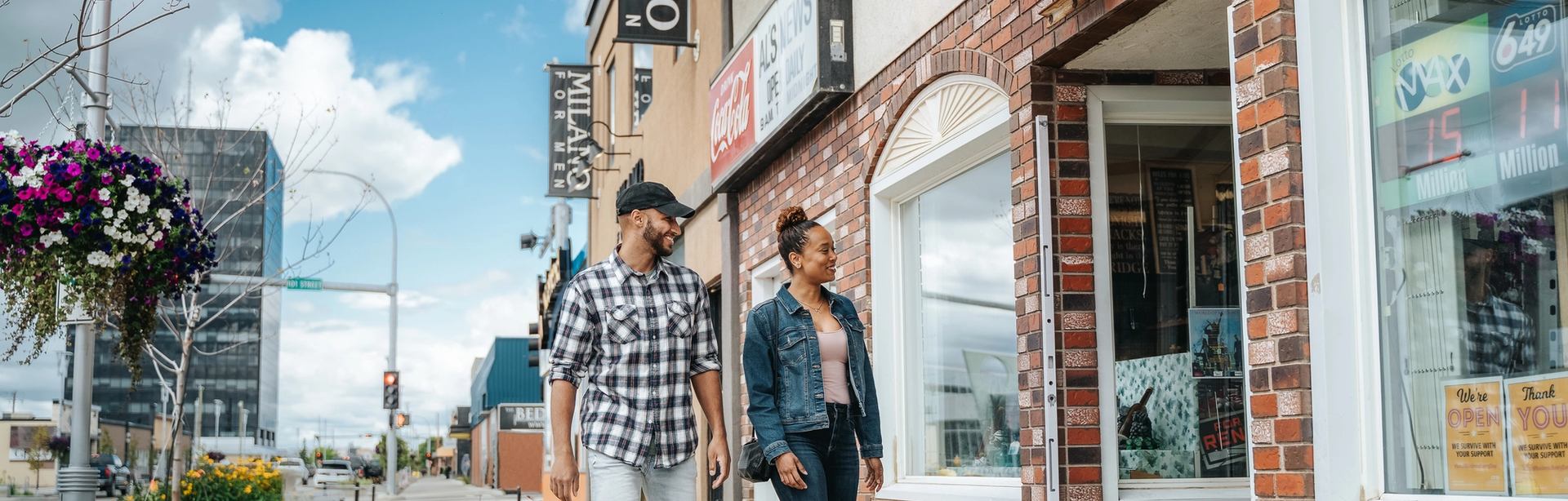 Couple walking through downtown Grande Prairie.