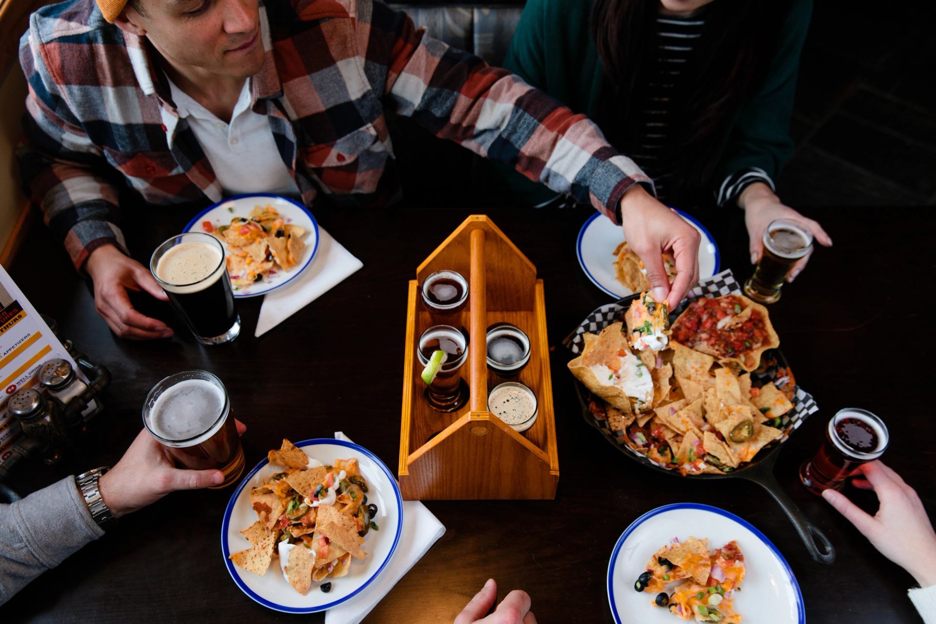 Friends enjoying craft beer and food at Jasper Brewing Company