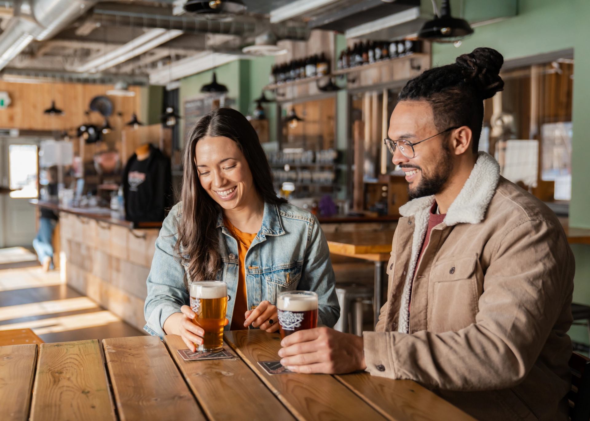 Man and woman enjoying a beverage at Hard Knox Brewery in Black Diamond