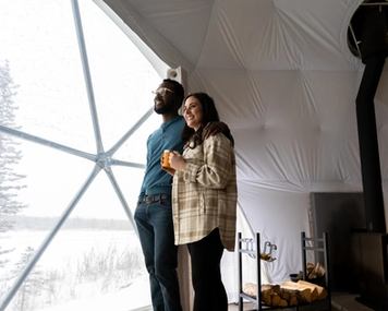 Couple looking out window of Camping Dome