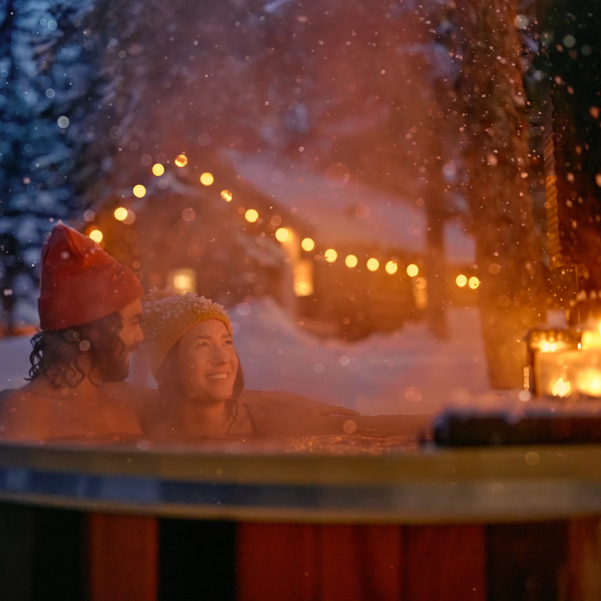 Couple sitting in a hot tub at Storm Mountain Lodge.