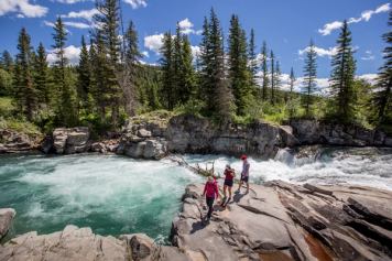 A group takes a guided hike along Castle Falls.