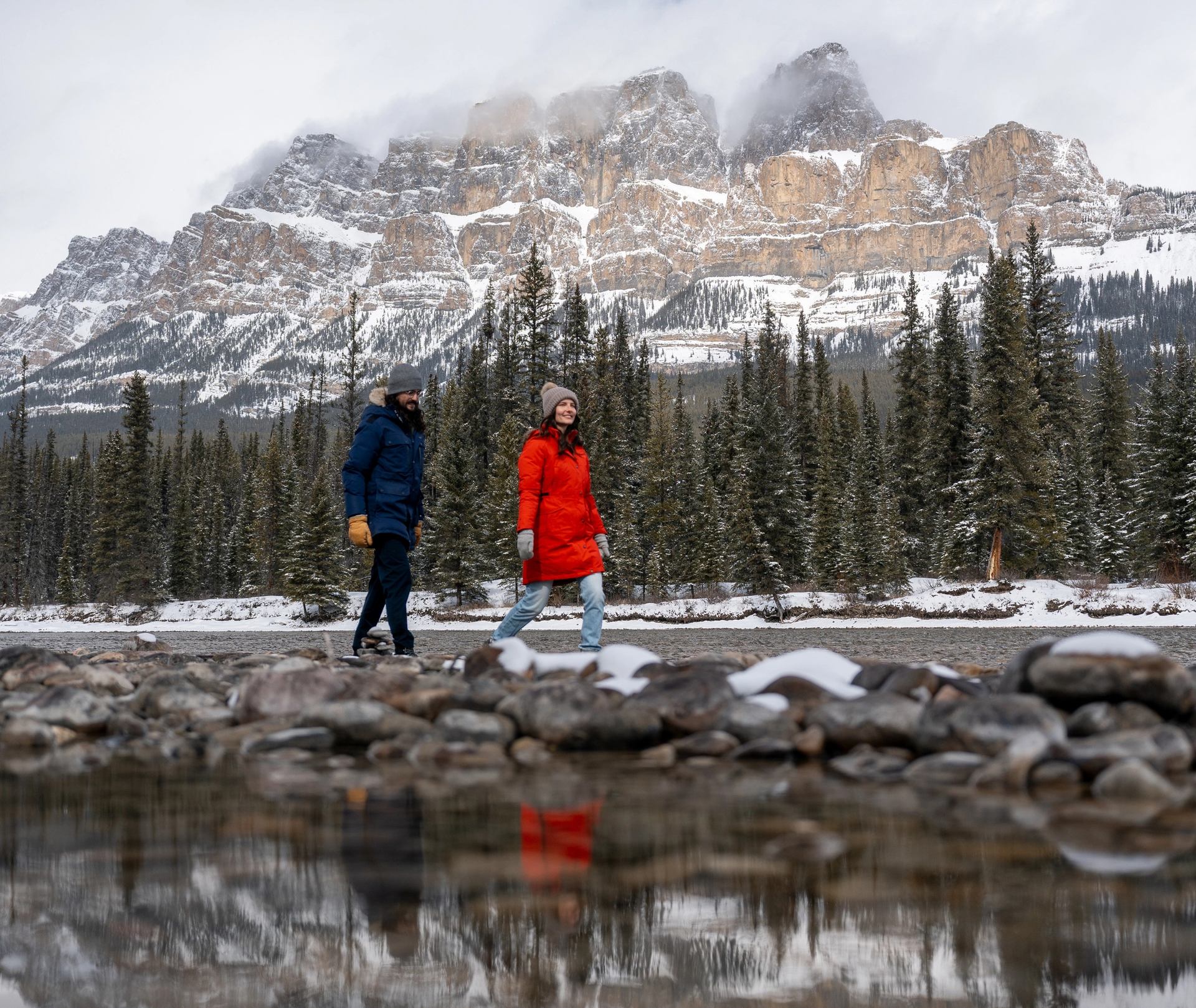 Walking along the river near Baker Creek Cabins with Castle Mountain in the background
