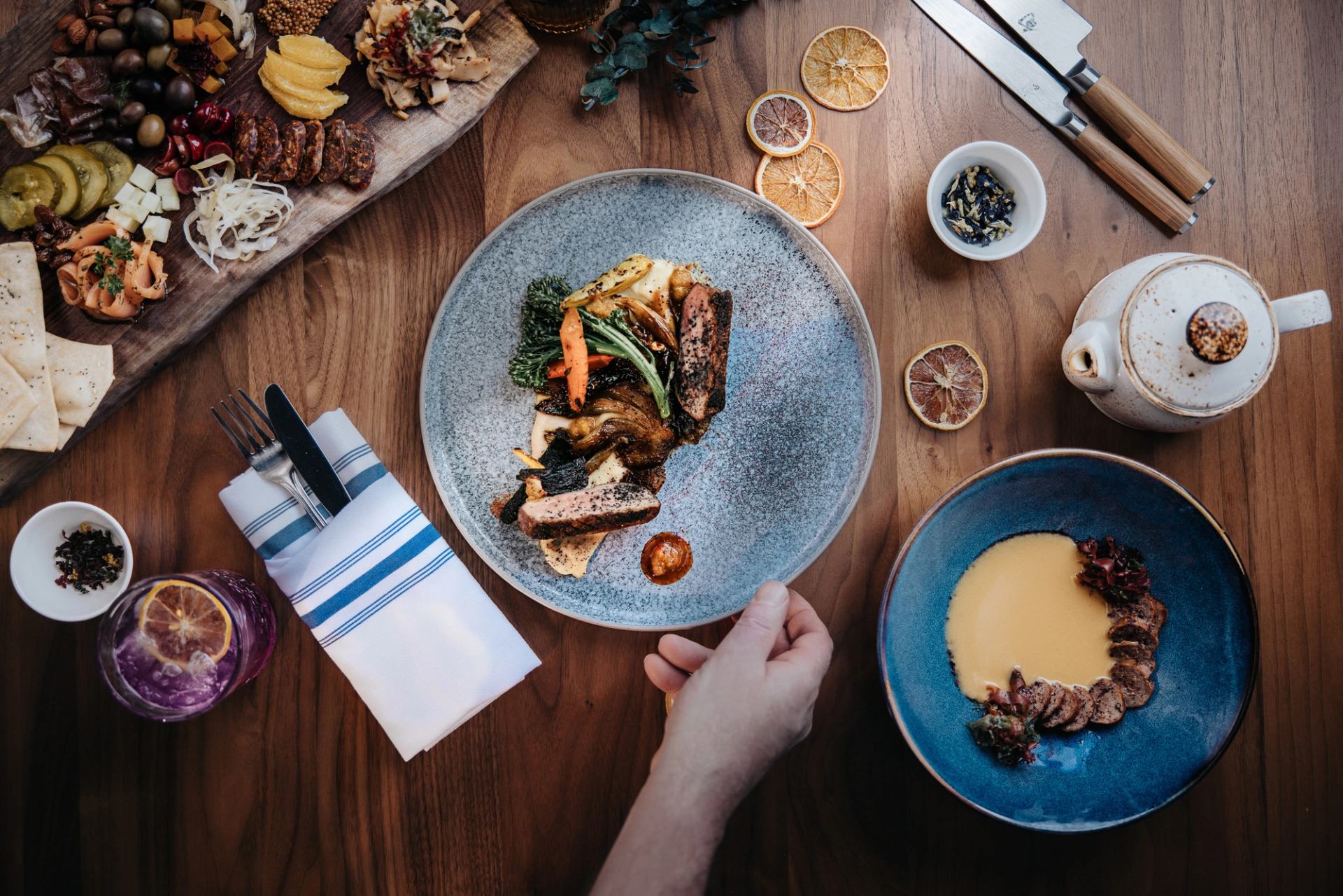 A closeup of a plate of food and other dishes on a table at Aalto in Jasper, Alberta.