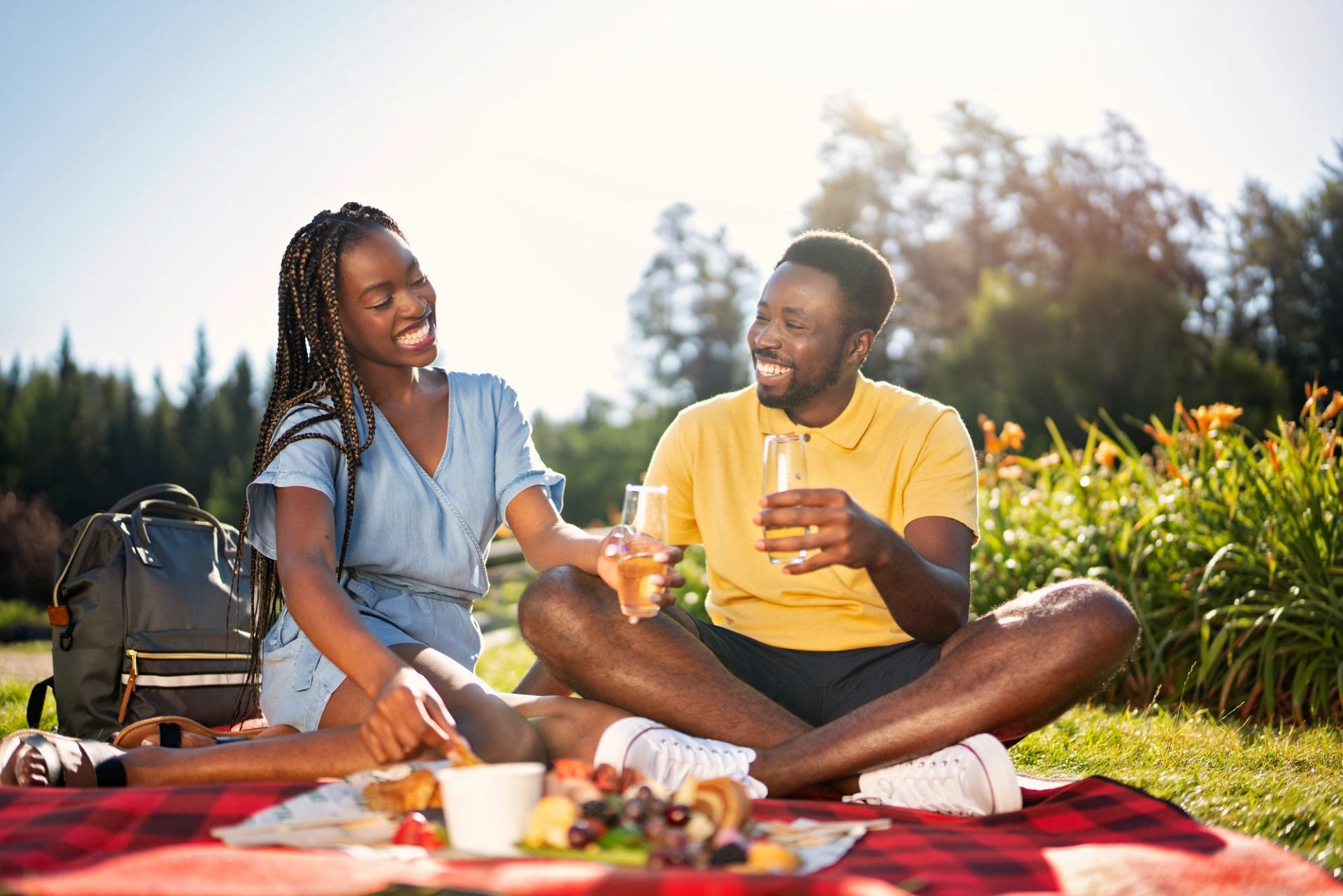 Couple have a picnic amid flowers and trees