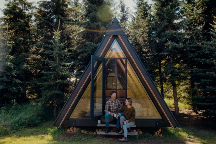 A couple set out for a hike from their A-frame cabin at Pine Creek Retreat