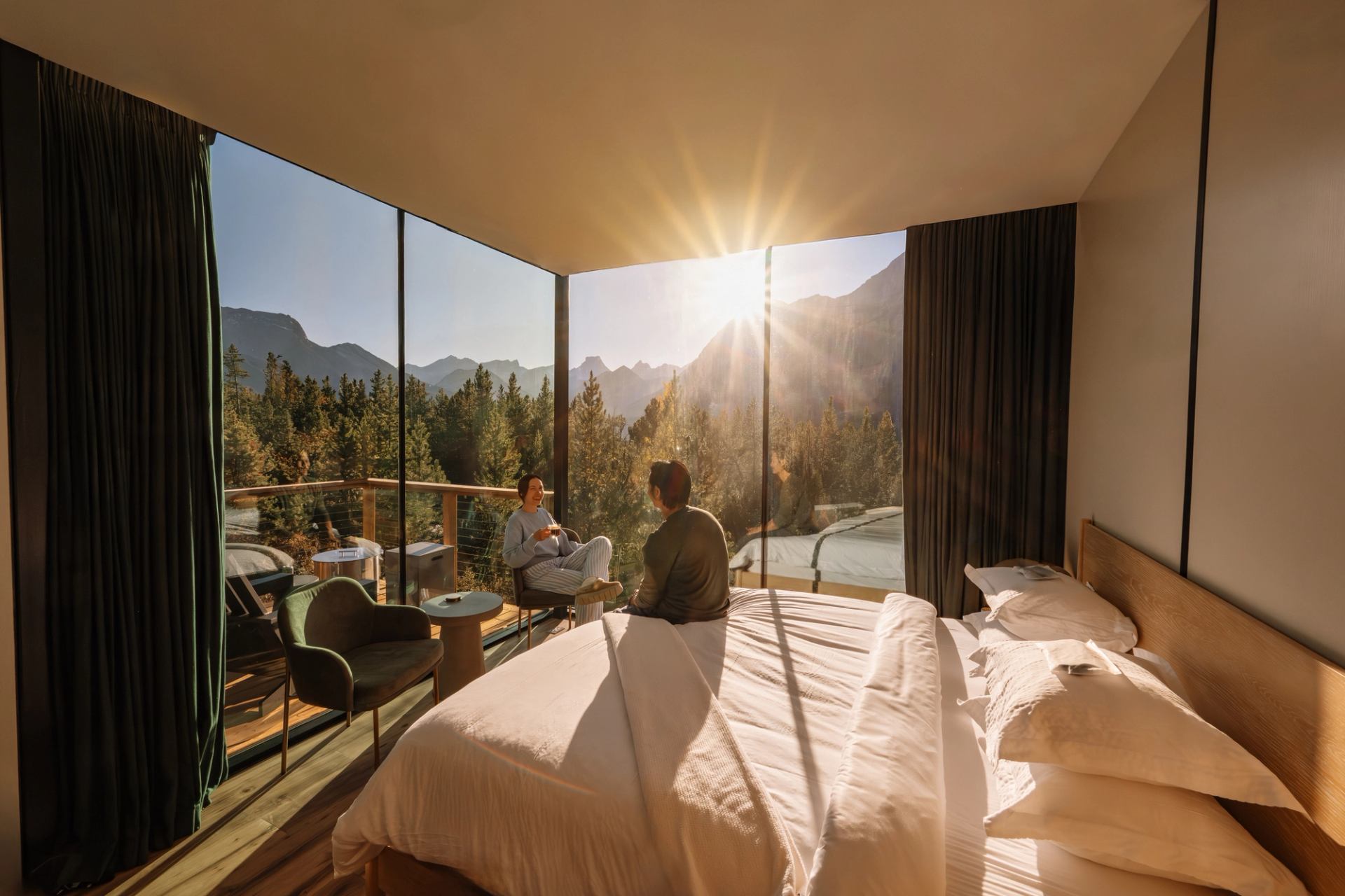A couple enjoys the view from their glamping suite at Skyridge in Kananaskis Country.